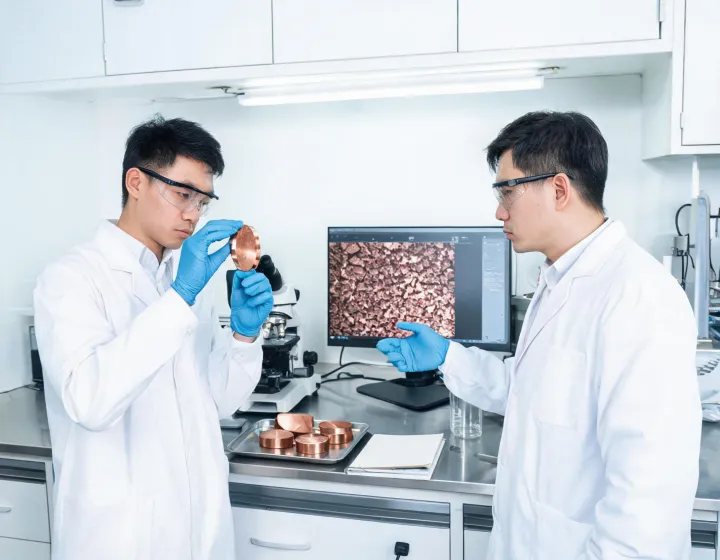 Metallurgical engineering team reviewing copper samples